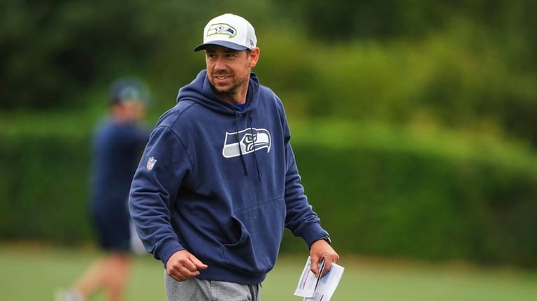 Seattle Seahawks offensive coordinator Klint Kubiak walks on the field...