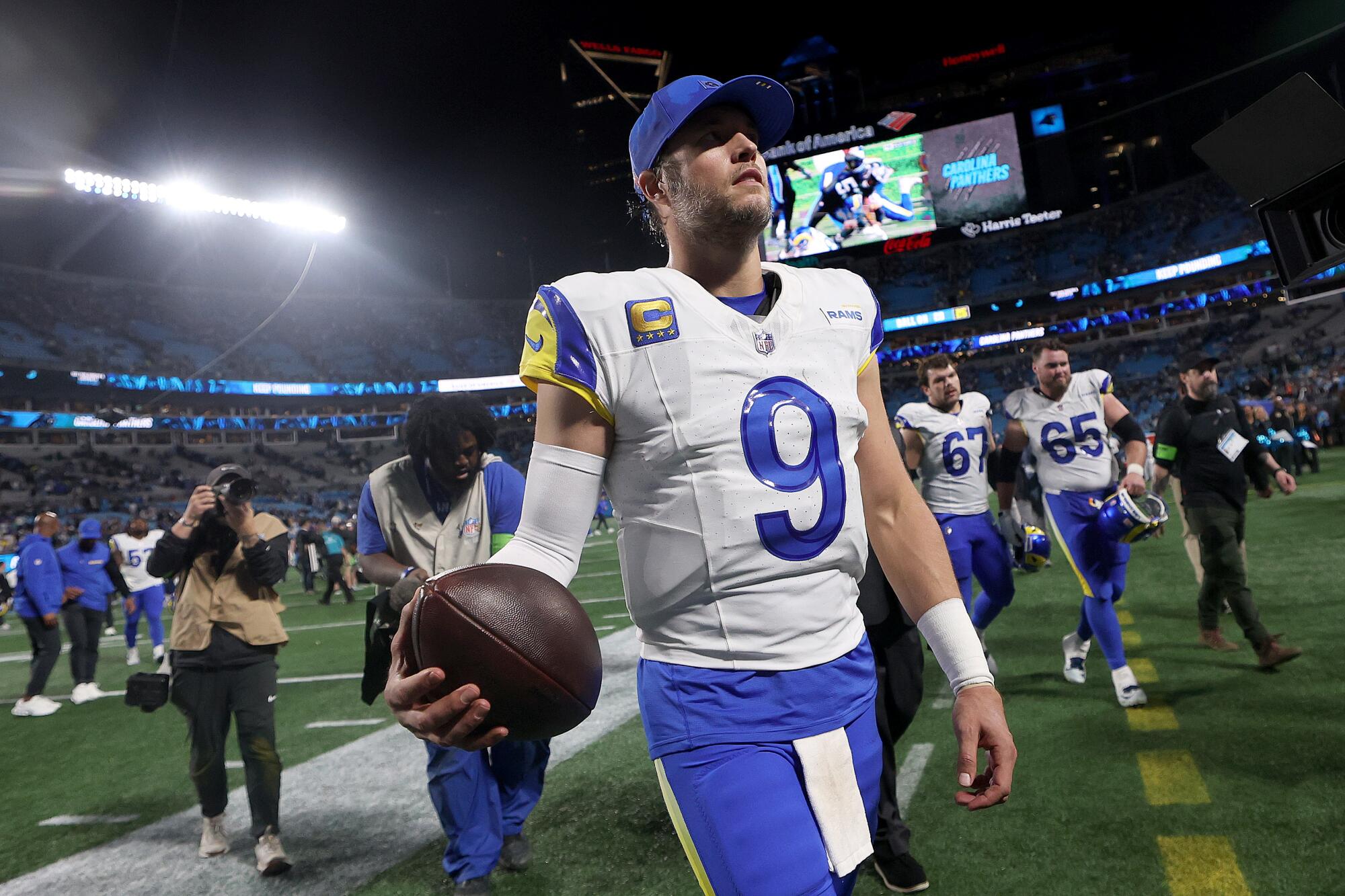 Rams quarterback Matthew Stafford walks off the field after a 34-31 playoff win over the Panthers on Saturday.