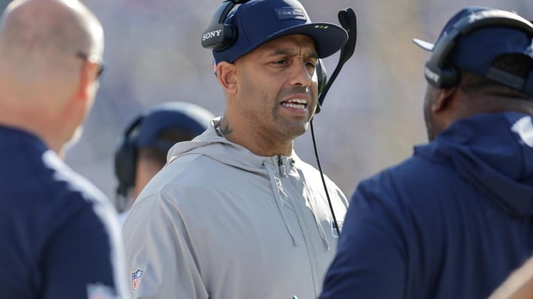 Seattle Seahawks defensive coordinator Aden Durde talks with coaches during...