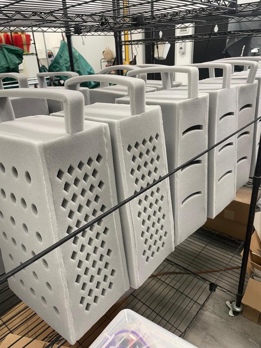 Foam Party Hats' popular "graterhead hats" are on a shelf.