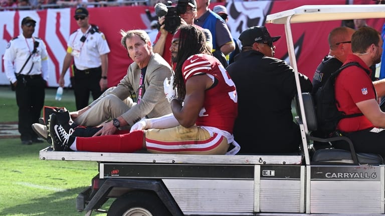 San Francisco 49ers middle linebacker Fred Warner is carted off...