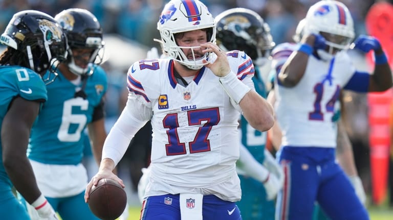Buffalo Bills quarterback Josh Allen gets up after collecting a...