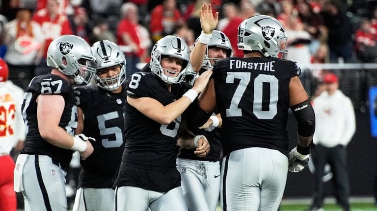 Las Vegas Raiders kicker Daniel Carlson (8) is congratulated by...