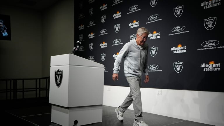 Las Vegas Raiders head coach Pete Carroll walks away from...