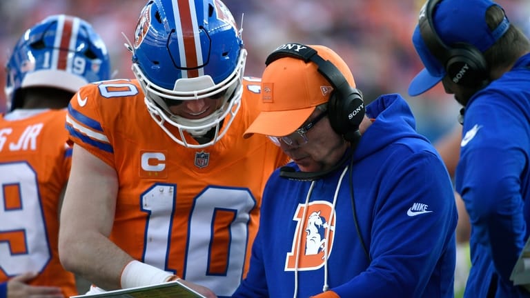 Denver Broncos head coach Sean Payton talks with quarterback Bo...