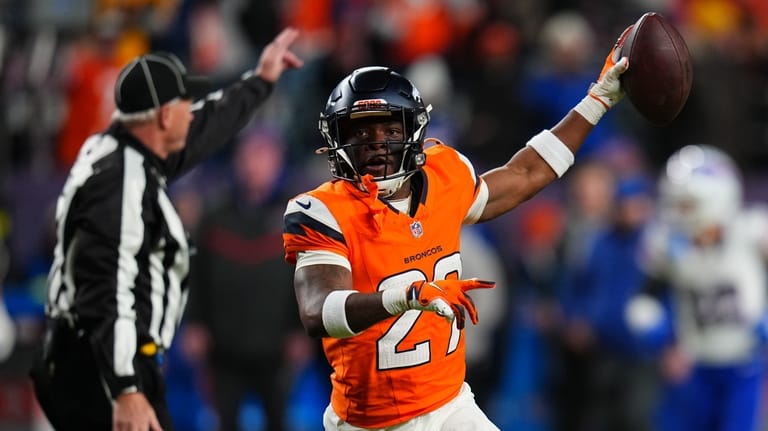 Denver Broncos cornerback Ja'quan McMillian reacts after intercepting a pass...
