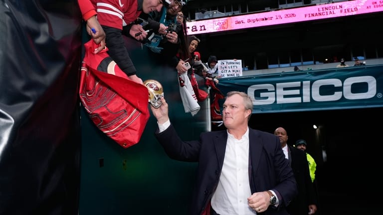 San Francisco 49ers General Manager John Lynch signs autographs before...