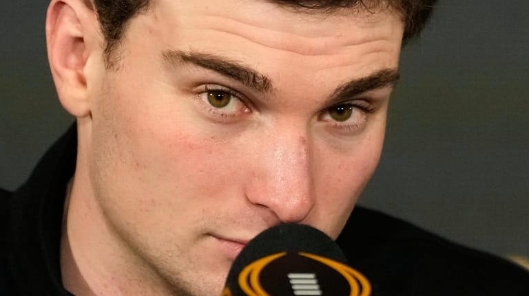 Indiana quarterback Fernando Mendoza speaks during the champions news conference...