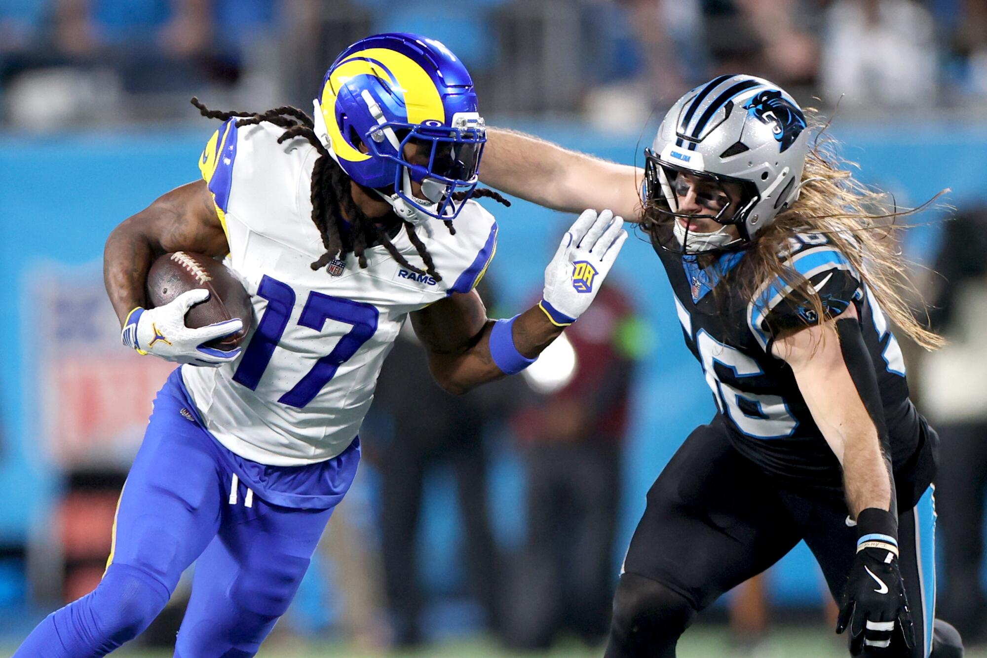 Rams wide receiver Davante Adams tries to run past Carolina Panthers linebacker Christian Rozeboom.