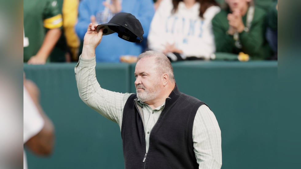 FILE - Former Green Bay Packers head coach Mike McCarthy waves during halftime of an NFL...