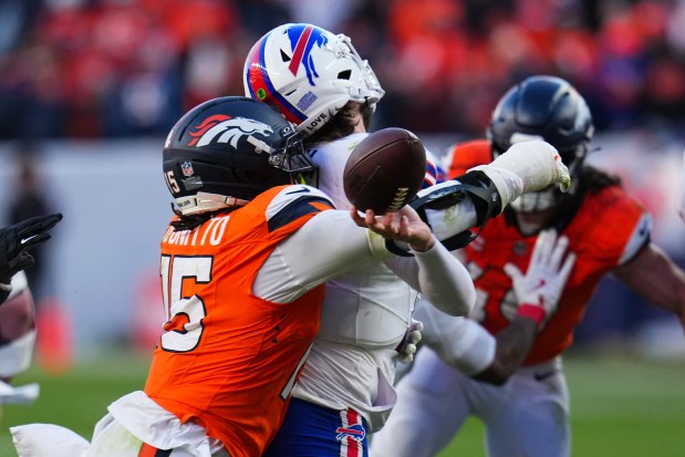 Buffalo Bills quarterback Josh Allen (17) fumbles the ball while being tackled by Denver Broncos linebacker Nik Bonitto (15) during the second half of an NFL divisional-round playoff game, Saturday, Jan. 17, 2026, in Denver. (AP Photo/Jack Dempsey)