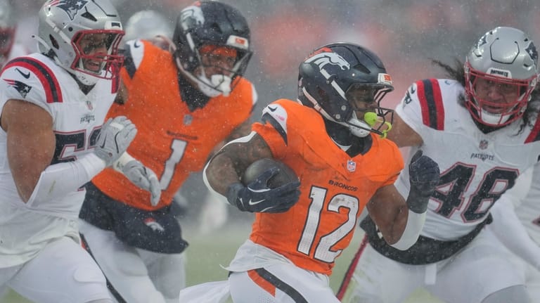 Denver Broncos running back RJ Harvey (12) runs as New...