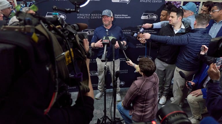 Seattle Seahawks general manager John Schneider, center, speaks during a...