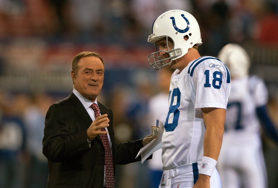 Peyton Manning #18 of the Indianapolis Colts talks with ABC sportscaster Al Michaels prior to playing the New York Giants in an NFL football game at Giants Stadium on September 10, 2006