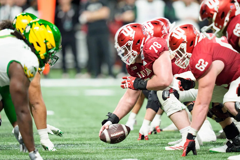 Indiana offensive lineman Pat Coogan snaps the ball as the Oregon Ducks face the Indiana Hoosiers in the Peach Bowl on Jan. 9, 2026, at Mercedes-Benz Stadium in Atlanta, Georgia.