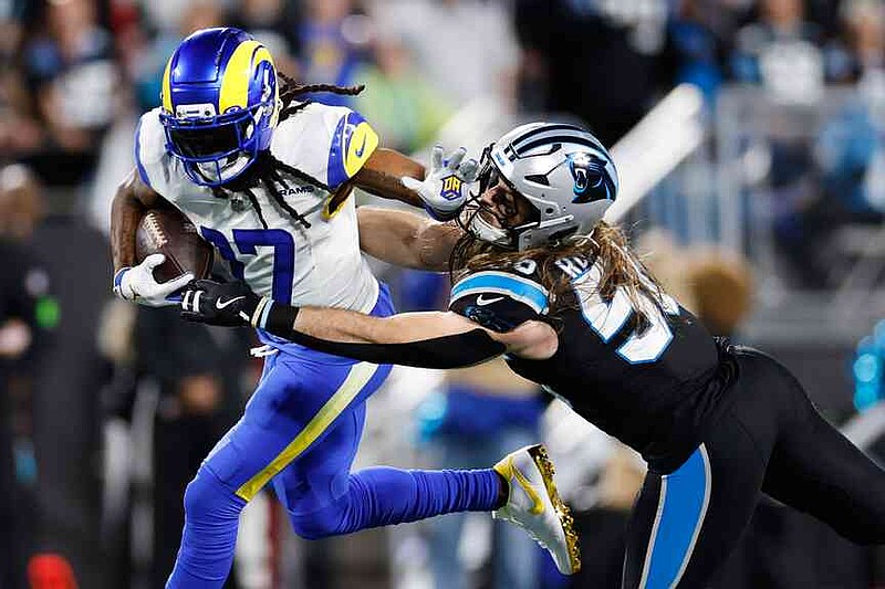 Los Angeles Rams wide receiver Davante Adams (17) is tackled by Carolina Panthers linebacker Christian Rozeboom during the second half of an NFL wild-card playoff football game, Saturday, Jan. 10, 2026, in Charlotte, N.C. (AP Photo/Rusty Jones)
