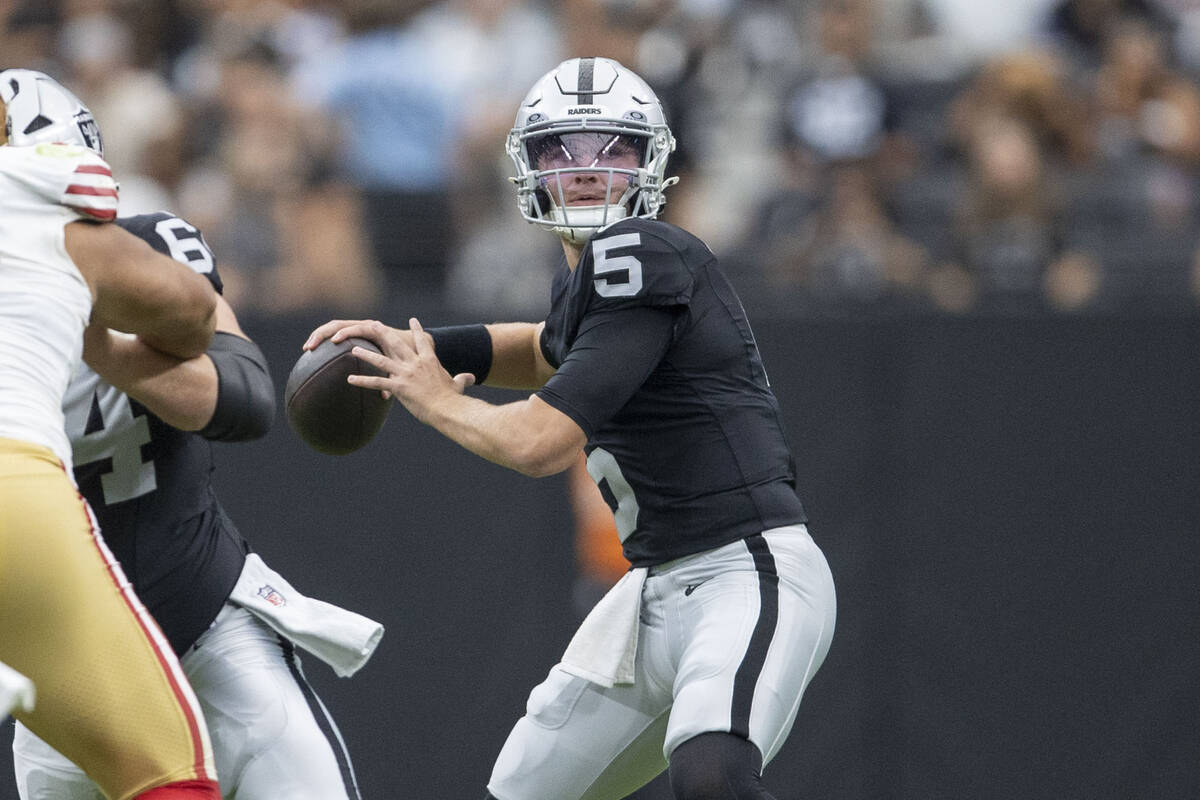 Raiders quarterback Cam Miller (5) drops back to throw against the San Francisco 49ers during t ...