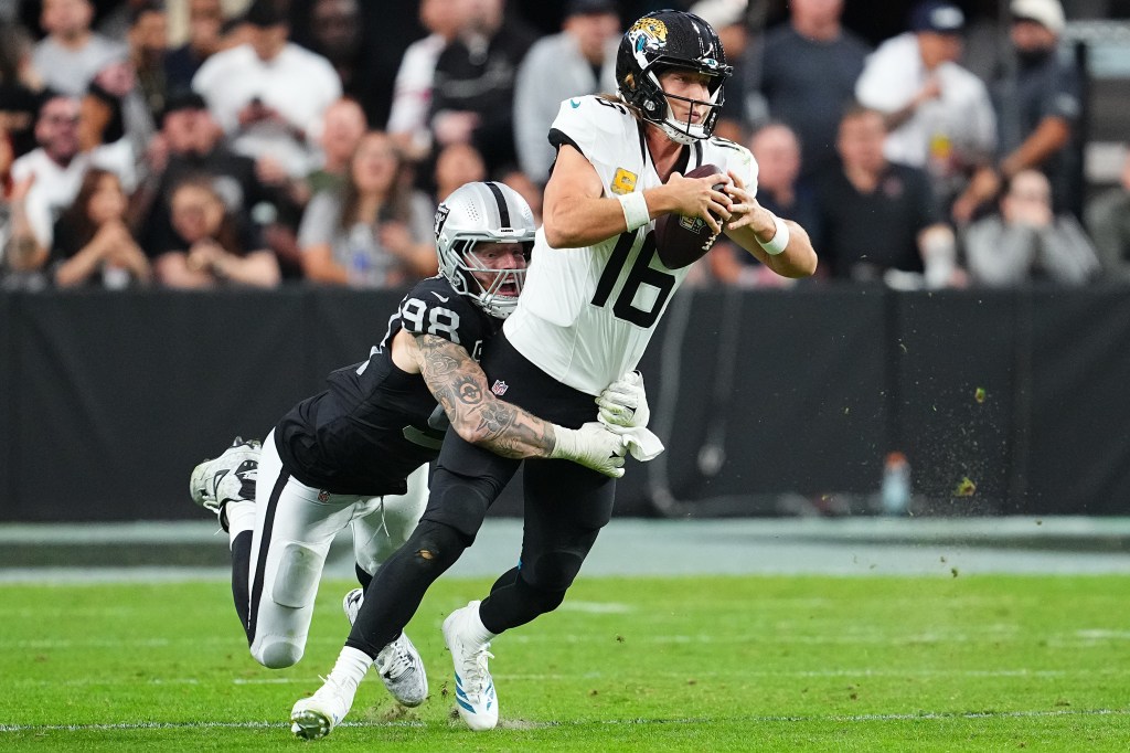Trevor Lawrence #16 of the Jacksonville Jaguars is sacked by Maxx Crosby #98 of the Las Vegas Raiders during the fourth quarter in the game at Allegiant Stadium on November 02, 2025 in Las Vegas, Nevada. 