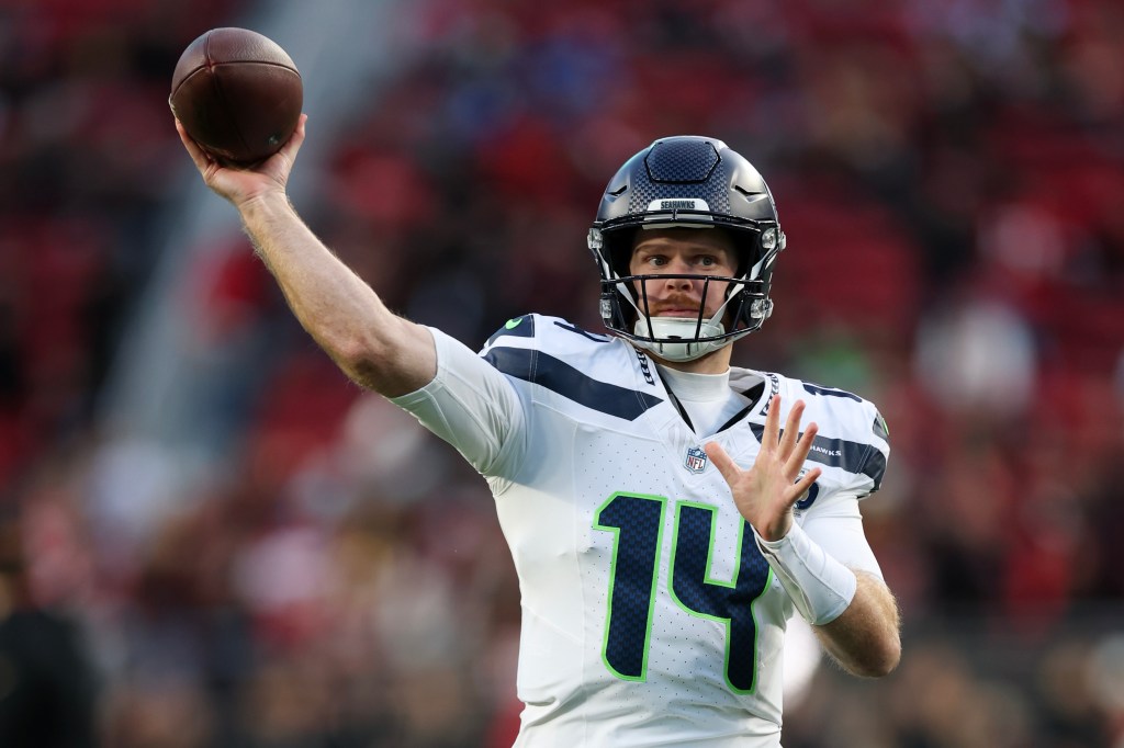 Seattle Seahawks quarterback Sam Howell wearing jersey number 14, throwing a pass.