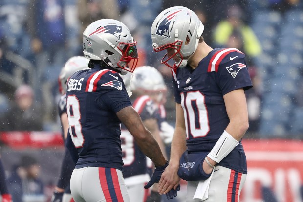 Drake Maye #10 and Stefon Diggs #8 of the New England Patriots warm up prior to the AFC Divisional Playoff game against the Houston Texans at Gillette Stadium on January 18, 2026 in Foxborough, Massachusetts. (Photo by Winslow Townson/Getty Images)