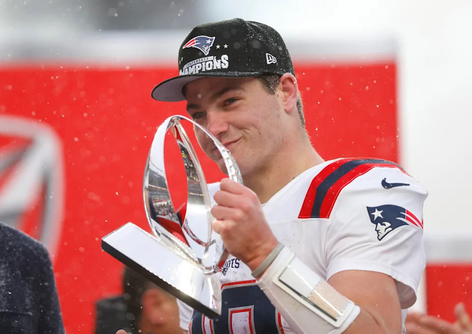 DENVER, COLORADO - JANUARY 25: Drake Maye #10 of the New England Patriots celebrates with the Lamar Hunt Trophy during the Trophy Presentation of the AFC Championship Playoff game against the Denver Broncos at Empower Field At Mile High on January 25, 2026 in Denver, Colorado. The New England Patriots defeat the Denver Broncos 10-7. (Photo by Justin Edmonds/Getty Images)