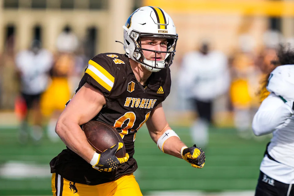 Nov 18, 2023; Laramie, Wyoming, USA; Wyoming Cowboys tight end John Michael Gyllenborg (84) scores a touchdown against the Hawaii Rainbow Warriors during the first quarter at Jonah Field at War Memorial Stadium. Mandatory Credit: Troy Babbitt-USA TODAY Sports