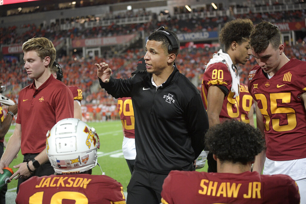 Iowa State running game coordinator Nate Scheelhaase, center, talks to players on the sideline during the second half of the Cheez-It Bowl NCAA college football game against Clemson, Wednesday, Dec. 29, 2021, in Orlando, Fla.