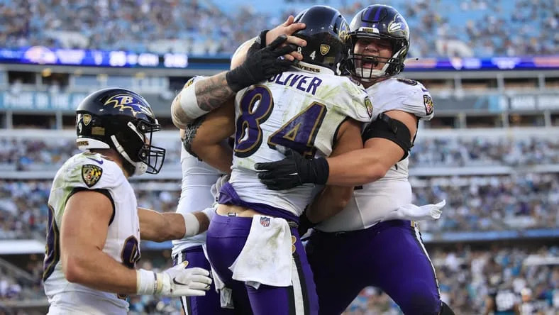 Baltimore Ravens tight end Josh Oliver (84) is embraced by center Tyler Linderbaum (64), right, as Baltimore Ravens tight end Mark Andrews (89), left, looks on after Oliver scored a touchdown during the fourth quarter of a regular season NFL football matchup Sunday, Nov. 27, 2022 at TIAA Bank Field in Jacksonville. The Jaguars edged the Ravens 28-27. [Corey Perrine/Florida Times-Union]