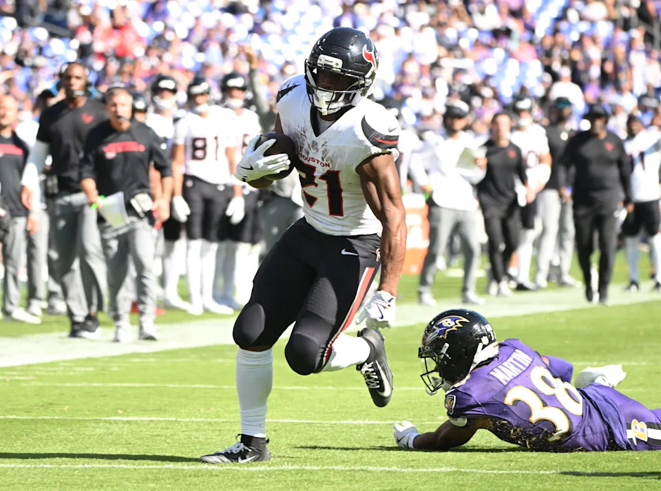 Oct 5, 2025; Baltimore, Maryland, USA; Houston Texans running back Nick Chubb (21) runs for a gain past Baltimore Ravens cornerback Keyon Martin (38) during the third quarter at M&T Bank Stadium. Mandatory Credit: Rafael Suanes-Imagn Images