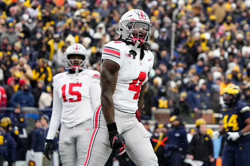 Ohio State Buckeyes wide receiver Jeremiah Smith (4) celebrates a touchdown during the NCAA football game against the Michigan Wolverines at Michigan Stadium in Ann Arbor, Mich. on Nov. 29, 2025.© Adam Cairns&sol;Columbus Dispatch &sol; USA TODAY NETWORK via Imagn Images