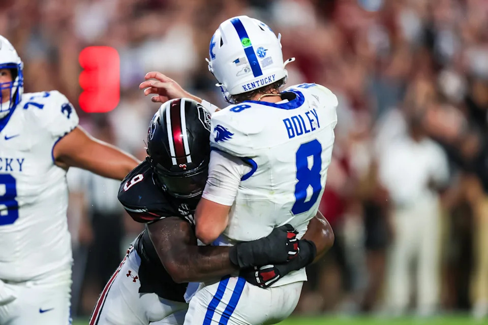 Sep 27, 2025; Columbia, South Carolina, USA; South Carolina Gamecocks linebacker Desmond Umeozulu (9) hits Kentucky Wildcats quarterback Cutter Boley (8) as he passes which causes an interception in the second quarter at Williams-Brice Stadium. Mandatory Credit: Jeff Blake-Imagn Images