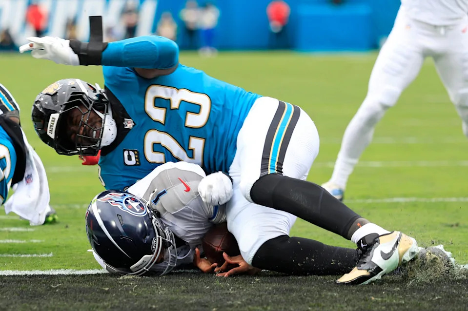(EDITOR'S NOTE: Resubmitted with alternate crop.) Tennessee Titans quarterback Cam Ward (1) scores a touchdown but is injured on the play as Jacksonville Jaguars linebacker Foyesade Oluokun (23) makes contact during the first quarter of an NFL football matchup at EverBank Stadium, Sunday, Jan. 4, 2026, in Jacksonville, Fla. The Jaguars defeated the Titans 41-7, capturing the AFC South title. [Corey Perrine/Florida Times-Union]