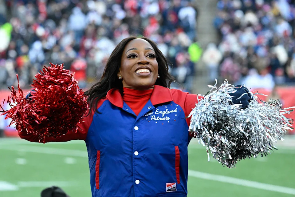 A New England Patriots cheerleader entertains fans during the first half against the Indianapolis Colts at Gillette Stadium.