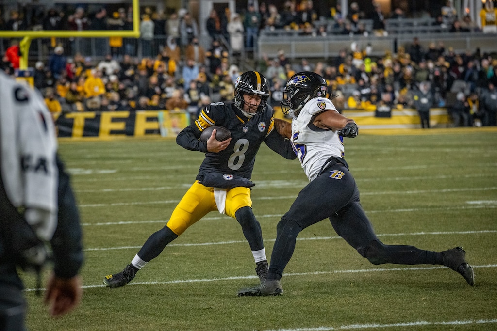 Baltimore Ravens linebacker Tavius Robinson (95) wraps up Pittsburgh Steelers quarterback Aaron Rodgers (8) on a run in the second quarter. The Steelers defeated the Ravens 26-24 at Acrisure Stadium in Pittsburgh.