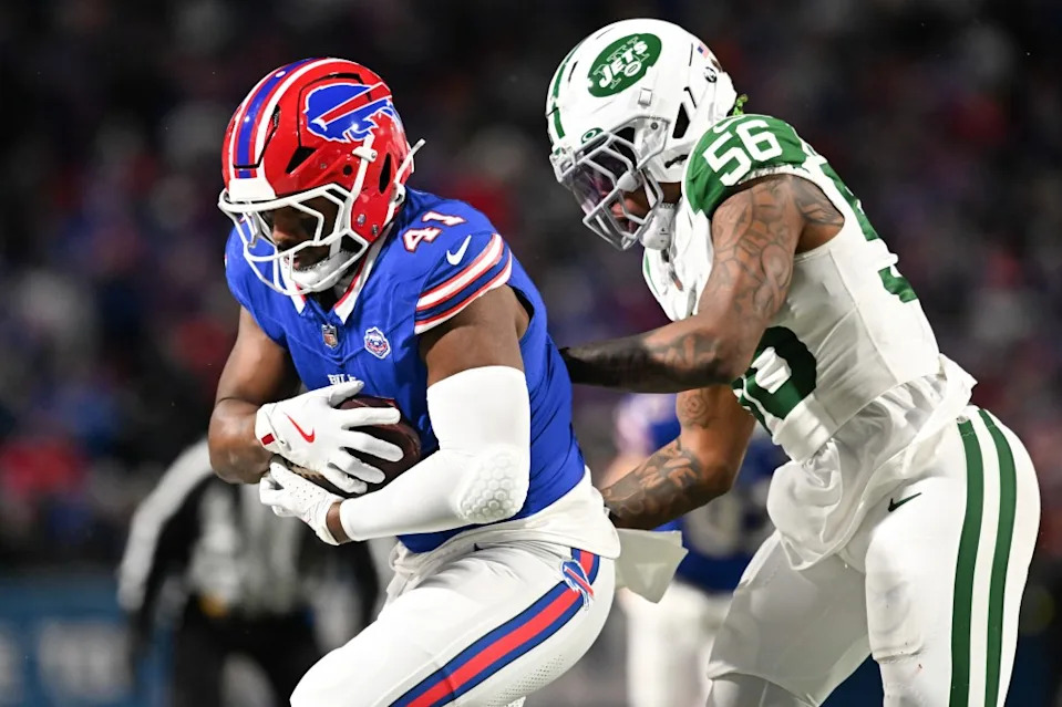 Buffalo Bills fullback Reggie Gilliam (41) carries the ball defended by New York Jets linebacker Quincy Williams (56) during the second quarter at Highmark Stadium. Mark Konezny-Imagn Images