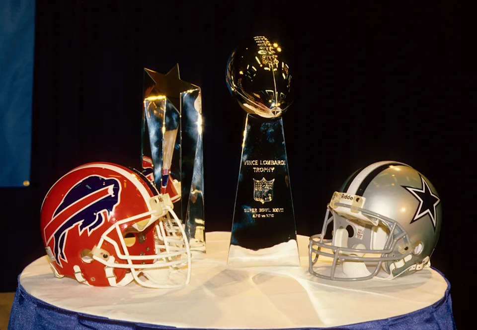 Jan 28, 1994; Atlanta, GA, USA; FILE PHOTO; Super Bowl XXVIII commissioner's press conference displays the team helmets of the Dallas Cowboys and Buffalo Bills and Super Bowl and mvp trophies. Mandatory Credit: Photo By USA TODAY Sports © Copyright 1994 USA TODAY Sports