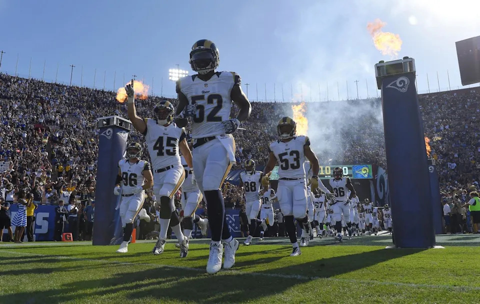 Rams players run out of the tunnel before a preseason game against the Dallas Cowboys on Aug. 13, 2016.