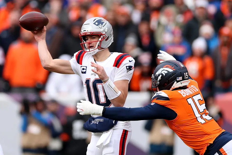 DENVER, COLORADO - JANUARY 25: Drake Maye #10 of the New England Patriots is pressured by Nik Bonitto #15 of the Denver Broncos during the first quarter in the AFC Championship Playoff game at Empower Field At Mile High on January 25, 2026 in Denver, Colorado. (Photo by Matthew Stockman/Getty Images)