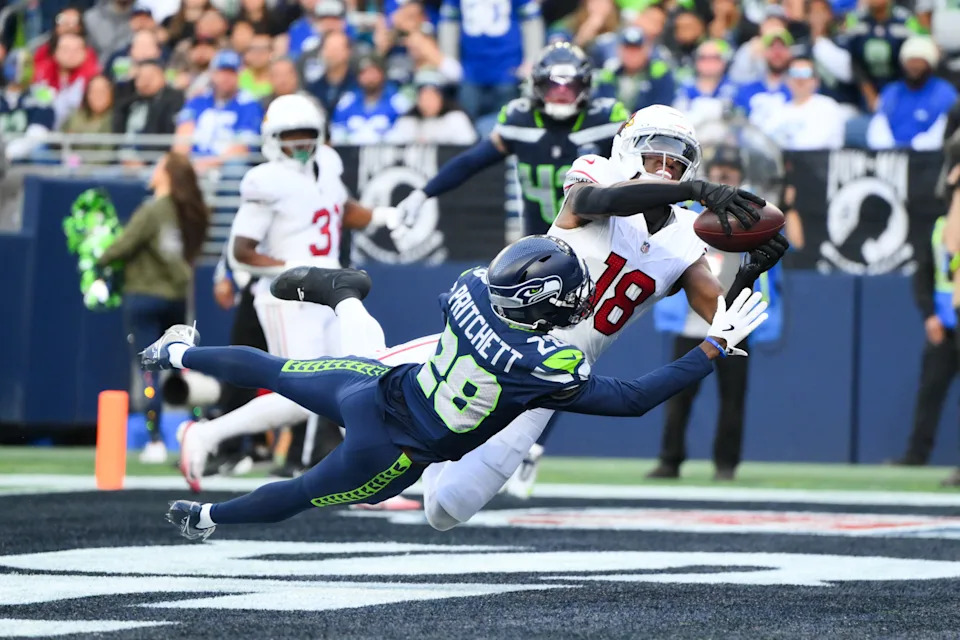 Seattle Seahawks cornerback Nehemiah Pritchett breaks up a pass intended for Arizona Cardinals wide receiver Marvin Harrison Jr.