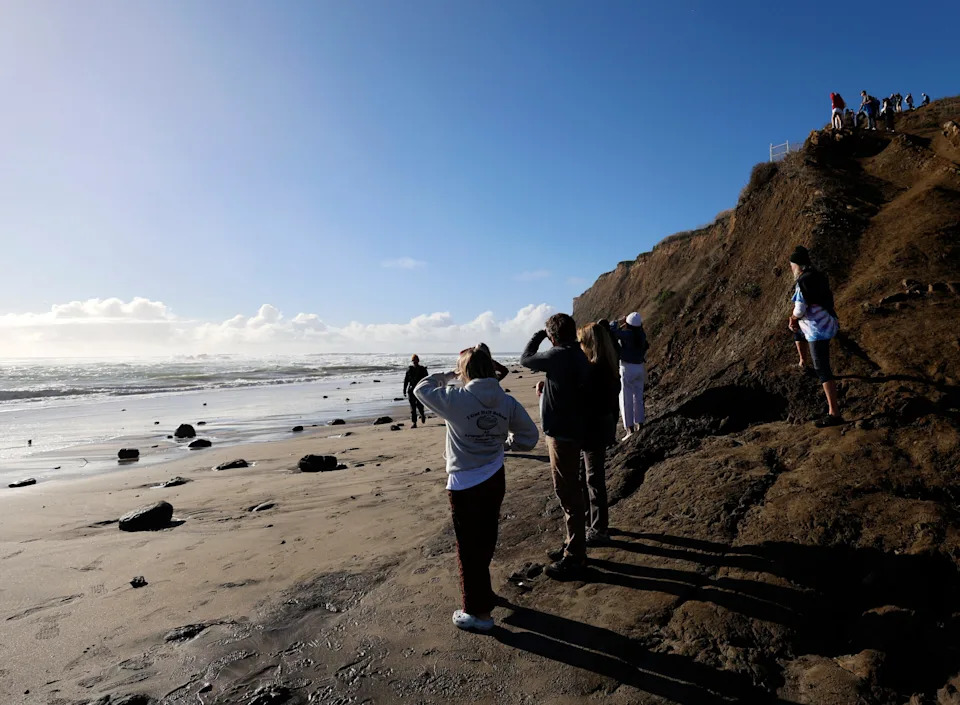 People gather to watch the waves at Mavericks Beach in Half Moon Bay, California, on Dec. 30, 2023.