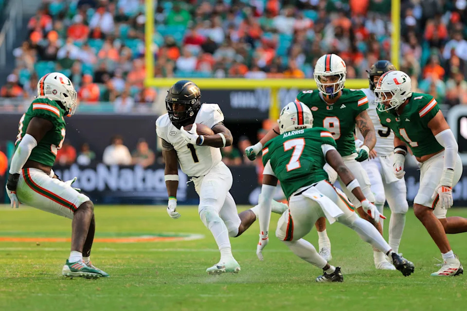 Nov 23, 2024; Miami Gardens, Florida, USA; Wake Forest Demon Deacons running back Demond Claiborne (1) runs with the football against the Miami Hurricanes during the second quarter at Hard Rock Stadium. Mandatory Credit: Sam Navarro-Imagn Images