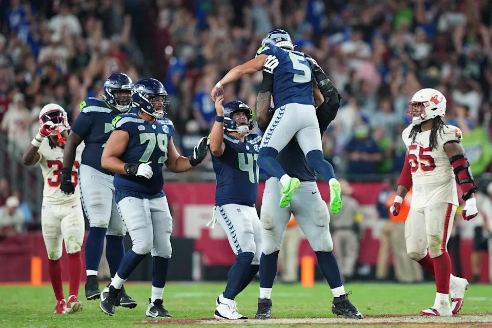 Seattle Seahawks' Jason Myers celebrates with long snapper Chris Stoll and teammates after kicking a game-winning field goal against the Arizona Cardinals.