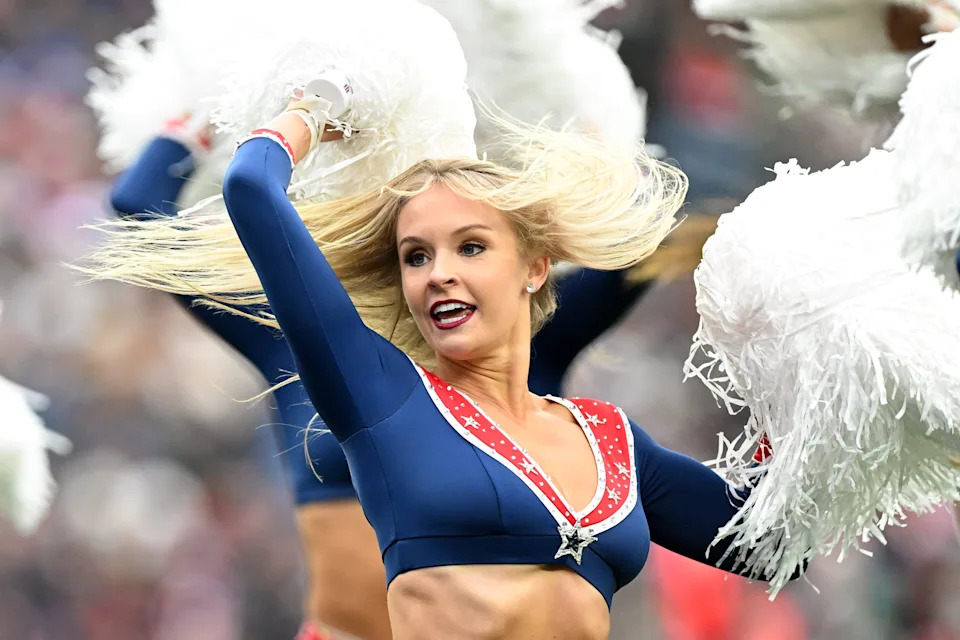 A New England Patriots cheerleader performs during the second half of a game against the Houston Texans at Gillette Stadium.
