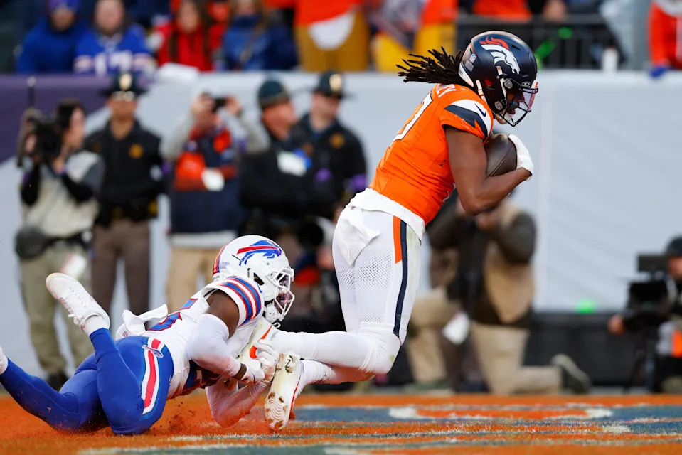 Lil'Jordan Humphrey #17 of the Denver Broncos scores a 29 touchdown against Darnell Savage #25 of the Buffalo Bills during the second quarter in the AFC Divisional Playoff game at Empower Field At Mile High on January 17, 2026 in Denver, Colorado.