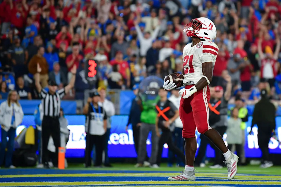 Nov 8, 2025; Pasadena, California, USA; Nebraska Cornhuskers running back Emmett Johnson (21) celebrates his touchdown scored against the UCLA Bruins during the first half at the Rose Bowl. Mandatory Credit: Gary A. Vasquez-Imagn Images