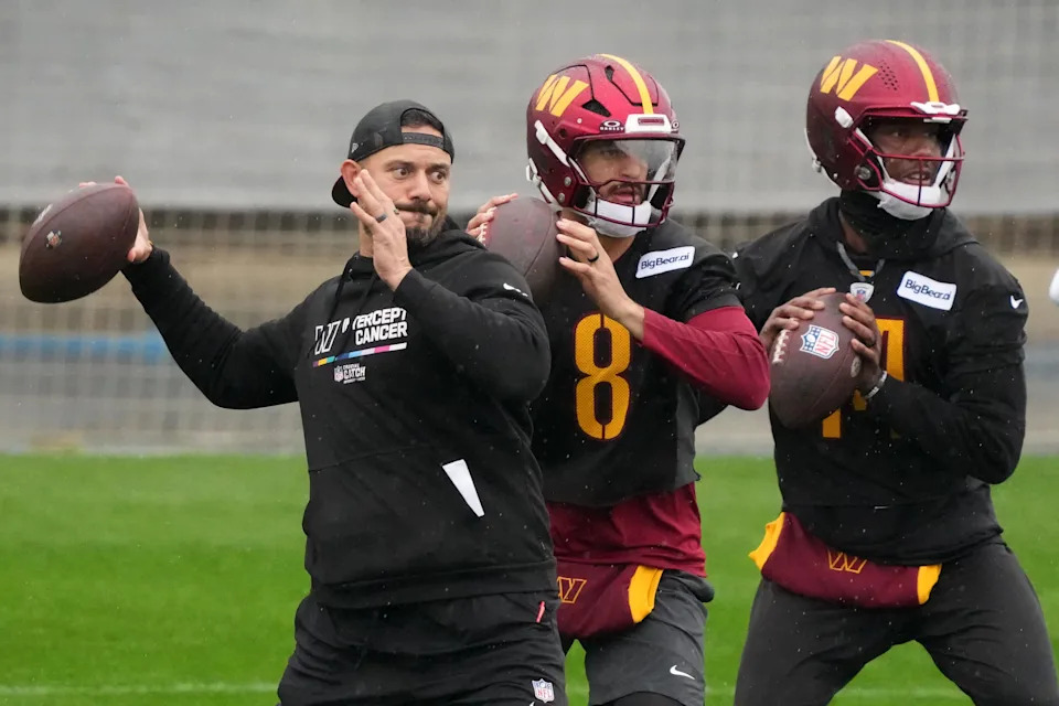 Nov 13, 2025; Madrid, Spain; Washington Commanders assistant quarterbacks coach David Blough (left) and quarterbacks Marcus Mariota (8) and Josh Johnson (14) throw the ball during practice at Ciudad Deportiva del Real Madrid. Mandatory Credit: Kirby Lee-Imagn Images