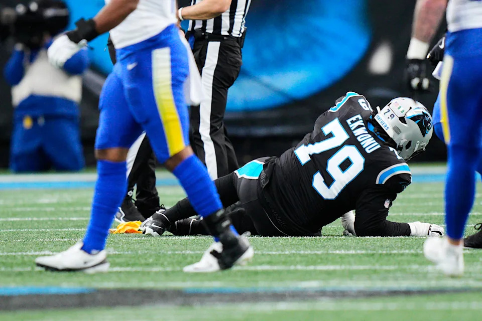 Carolina Panthers offensive tackle Ikem Ekwonu (79) goes down with an injury during the first half of an NFL wild-card playoff football game against the Los Angeles Rams, Saturday, Jan. 10, 2026, in Charlotte, N.C. (AP Photo/Jacob Kupferman)