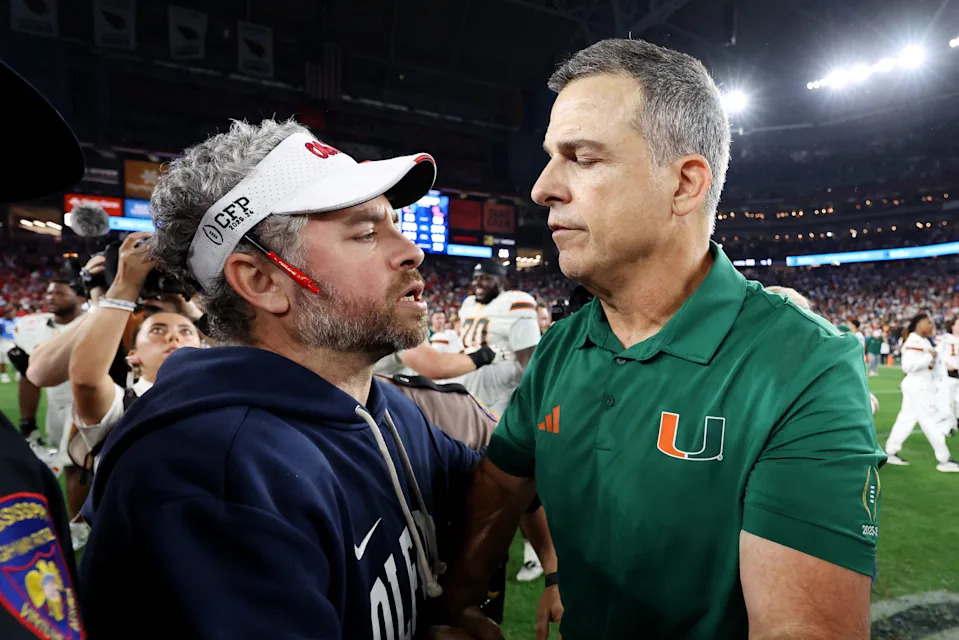 GLENDALE, ARIZONA - JANUARY 08: Head coach Pete Golding of the Ole Miss Rebels interacts with head coach Mario Cristobal of the Miami Hurricanes after the game during the 2025 College Football Playoff Semifinal at the VRBO Fiesta Bowl at State Farm Stadium on January 08, 2026 in Glendale, Arizona. The Hurricanes defeated the Rebels 31-27. (Photo by Christian Petersen/Getty Images)