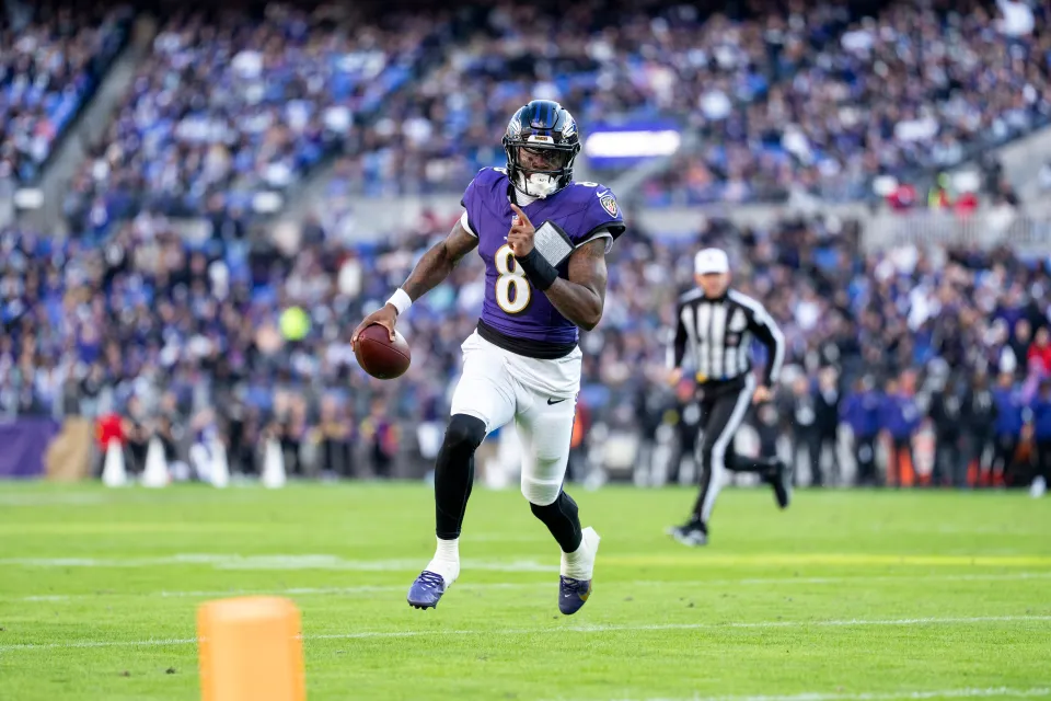 Lamar Jackson #8 of the Baltimore Ravens scrambles and runs with the ball during an NFL football game against the New York Jets