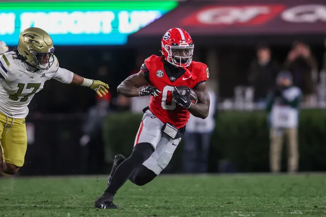 Nov 29, 2024; Athens, Georgia, USA; Georgia Bulldogs running back Roderick Robinson II (0) runs the ball against the Georgia Tech Yellow Jackets in the fourth quarter at Sanford Stadium.